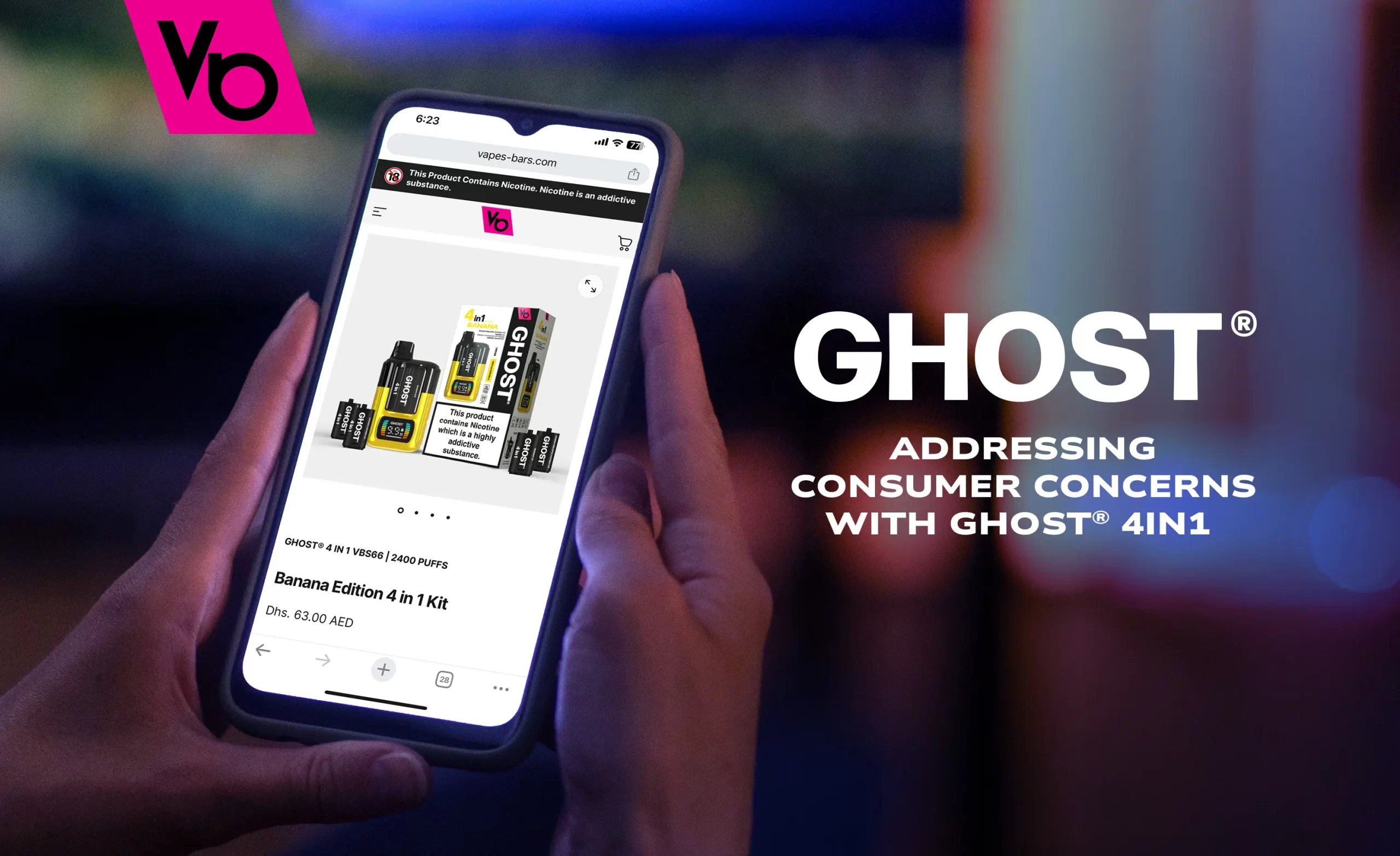 A hand holding a mobile phone with GhostVapes.com open, displaying the Ghost® 4 in 1 Banana Edition device.